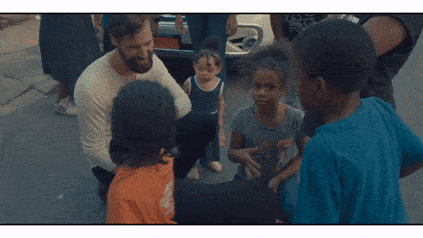 GIF of a person interacting with children and a dog