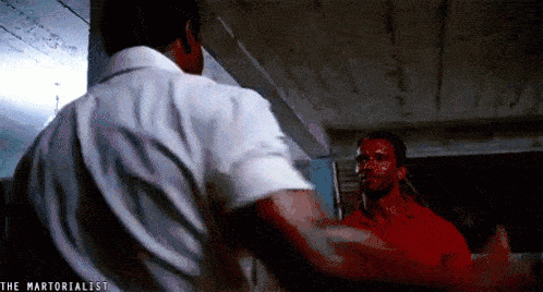 A gif of two muscular men greeting each other.