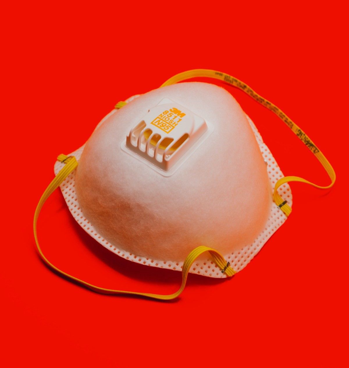 Respirator mask on a red background.
